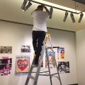 Perfecting the lighting of a series of exhibition prints during installation