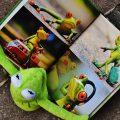 Kermit reads a book about frogs