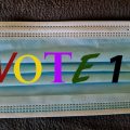 Image of a pandemic mask with digital word/ number 'Vote 1